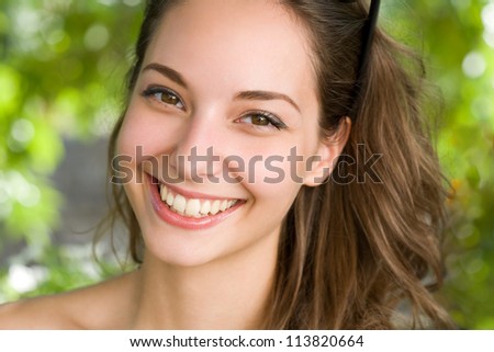 Closeup portrait of a beautiful  friendly young brunette woman.