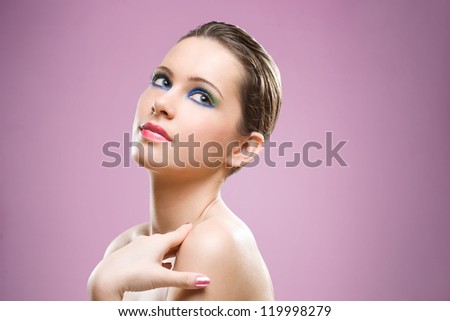 Portrait of feminine beauty in very colorful creative makeup.