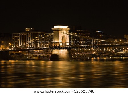 Golden glow on the Chain Bridge at night in Budapest.