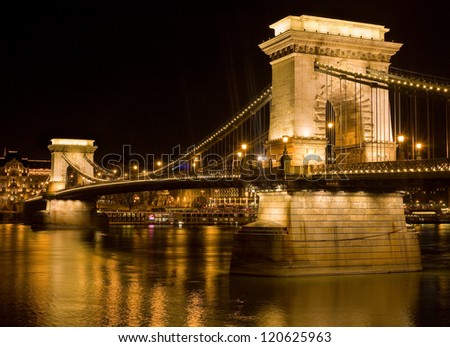 Golden glow on the Chain Bridge at night in Budapest.