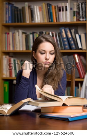 Portrait of busy young brunette student woman.