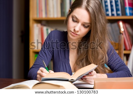 Portrait of a very busy young brunette student.
