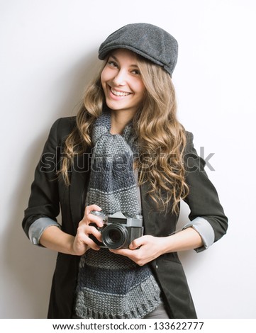 Portrait of fashionable young photo artist with vintage film camera.