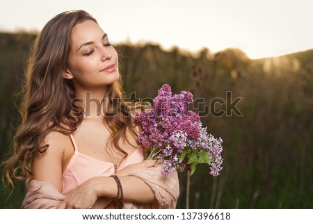 Romantic outdoors shots of stylish brunette beauty in spring nature.