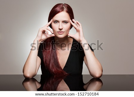 Portrait of a redhead beauty with strong facial expression.