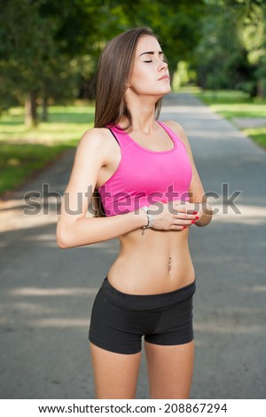 Portrait of a beautiful fit teen girl outdoors in the park.