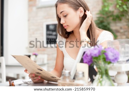Gorgeous young brunette woman in a fancy restaurant.