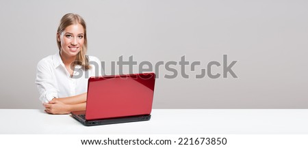Portrait of a beautiful young blond computer user.