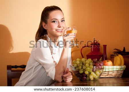 Portrait of gorgeous young brunette woman tasting wine.