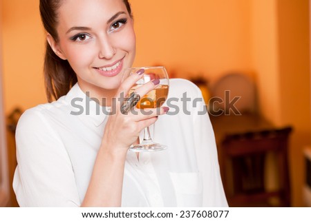 Portrait of gorgeous young brunette woman tasting wine.