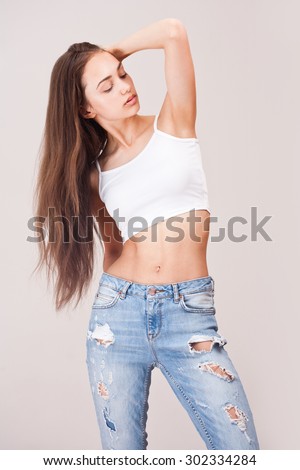 Portrait of a slim and fit beautiful woman in jeans.
