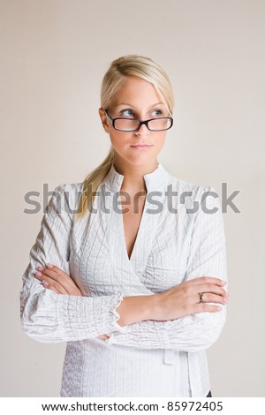 Portrait of friendly young business woman taking a sideways glance.