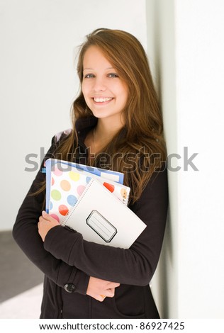 Half length portrait of fresh, cheerful young student girl.