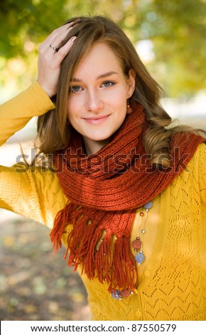 Half length portrait colorful fall fashion girl in the park.