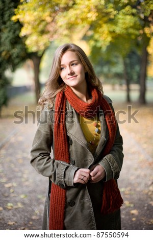 Half length portrait of stylish autumn fashion girl in the park.