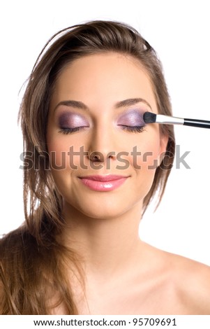 Cosmetics concept with beautiful young brunette woman and makeup tools.