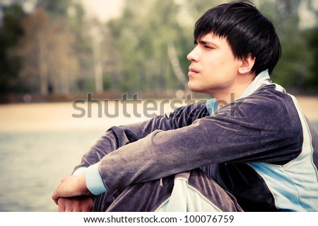 young man sit and relax by the river