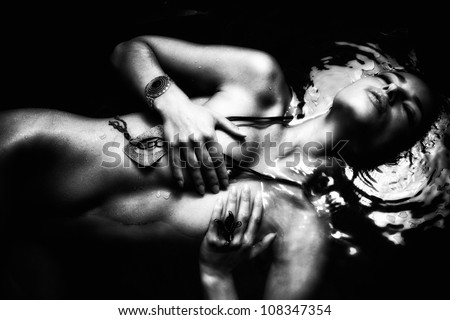 beautiful nude woman in  water black and white small amount of grain added