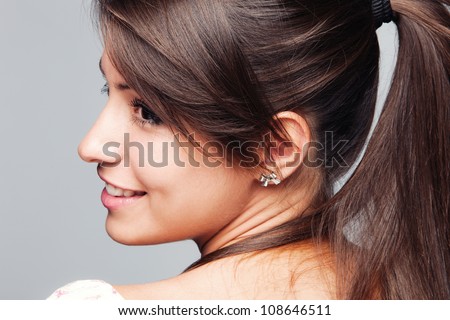 young woman with ponytail profile  studio shot