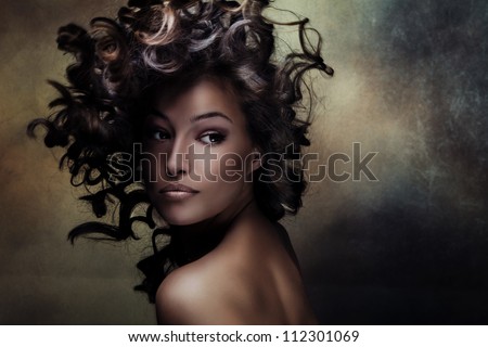 beautiful black young woman beauty shot with hair in motion