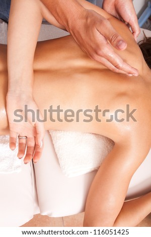 arms and upper back massage technique in spa salon