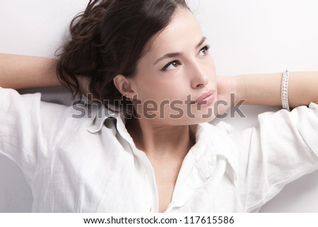 natural looking young woman portrait in white linen shirt studio shot