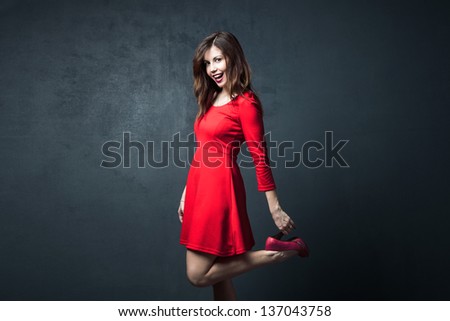 young woman dance in red short dress