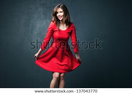young woman dance in red short dress