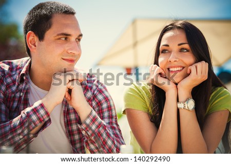 young couple on first date, outdoor shot summer day