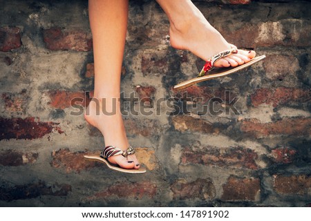 woman legs in  summer slippers outdoor day  shot  in the city