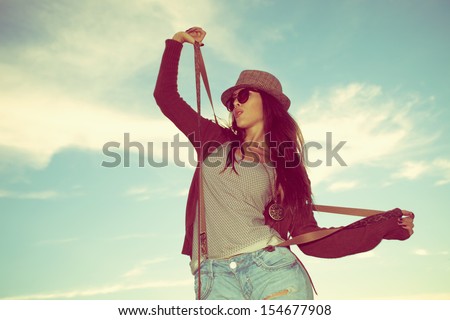 young hipster woman with hat and sunglasses outdoor shot