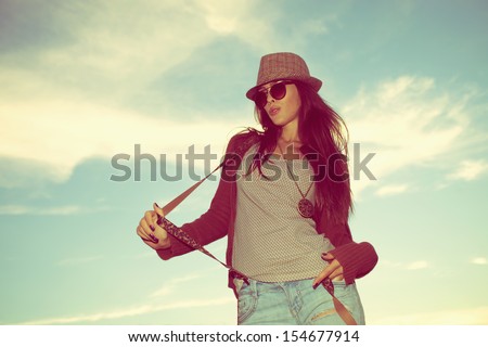 young hipster woman portrait with hat and sunglasses outdoor shot retro colors
