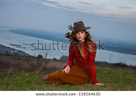 young blonde woman in autumn fashion clothes,  red leather jacket, hat, cashmere scarf and brown skirt outdoor shot