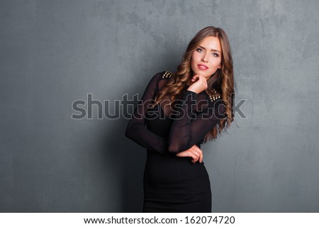woman in black elegant dress studio shot