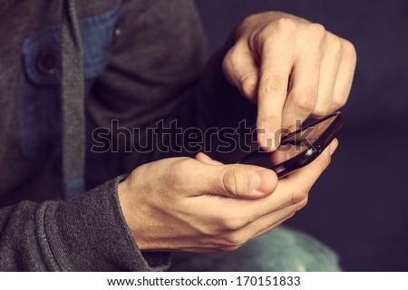 close up of a man using mobile smart phone