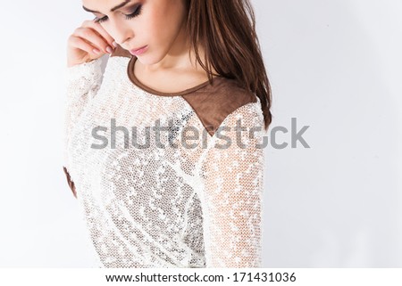 young fashion woman in sheer white sweater studio shot