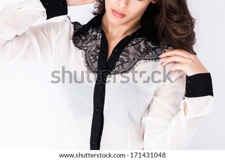 elegant woman white  shirt with embroidery black details studio shot