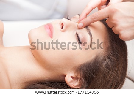 Woman Acupressure Face Massage Closeup