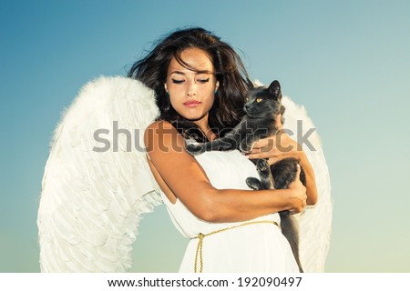 beautiful angel woman against sky with cat in her arms