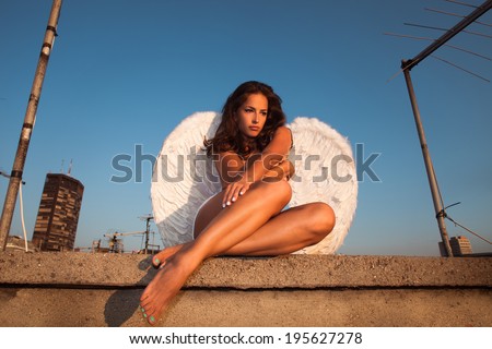 angel woman on building roof, summer day, Belgrade, Serbia