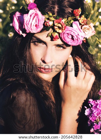 woman in field with flowers in hair