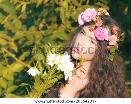 young woman in the field with flowers in hair