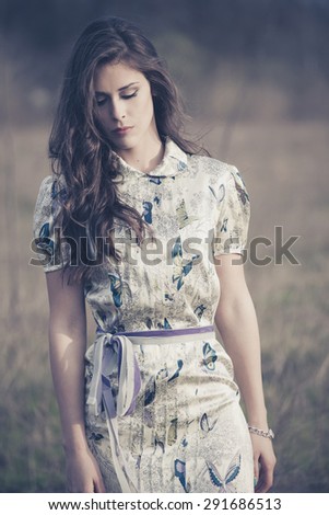 a young woman in a bad mood walking in the field