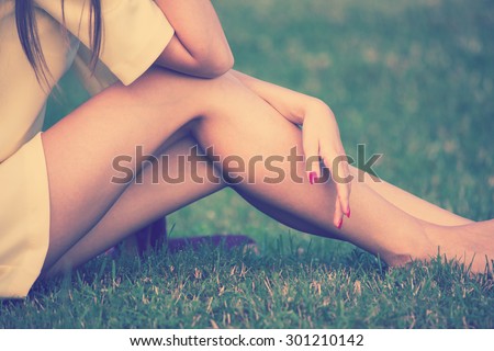 barefoot female legs in grass retro colors