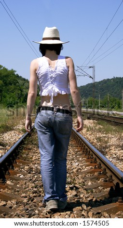 alone girl going on the rail tracks
