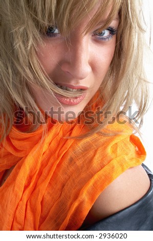 blond girl in leather jacket and orange scarf and wild hair