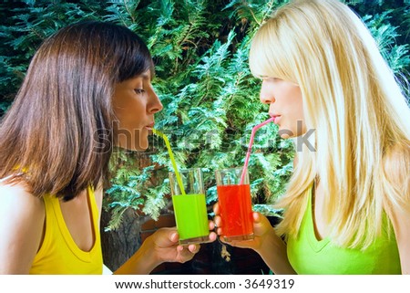 women outside drinking soft drink