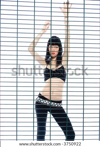 black hair woman behind wire net - fence