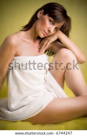 woman portrait, sitting with white towel, studio shot