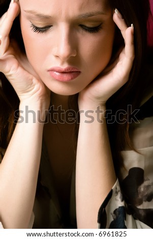 young woman with headache, studio shot